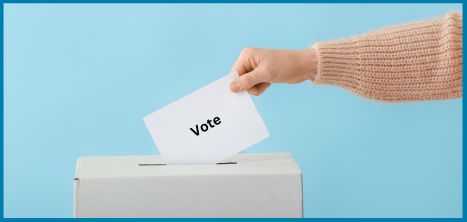 Arm reaching to place vote card into a box