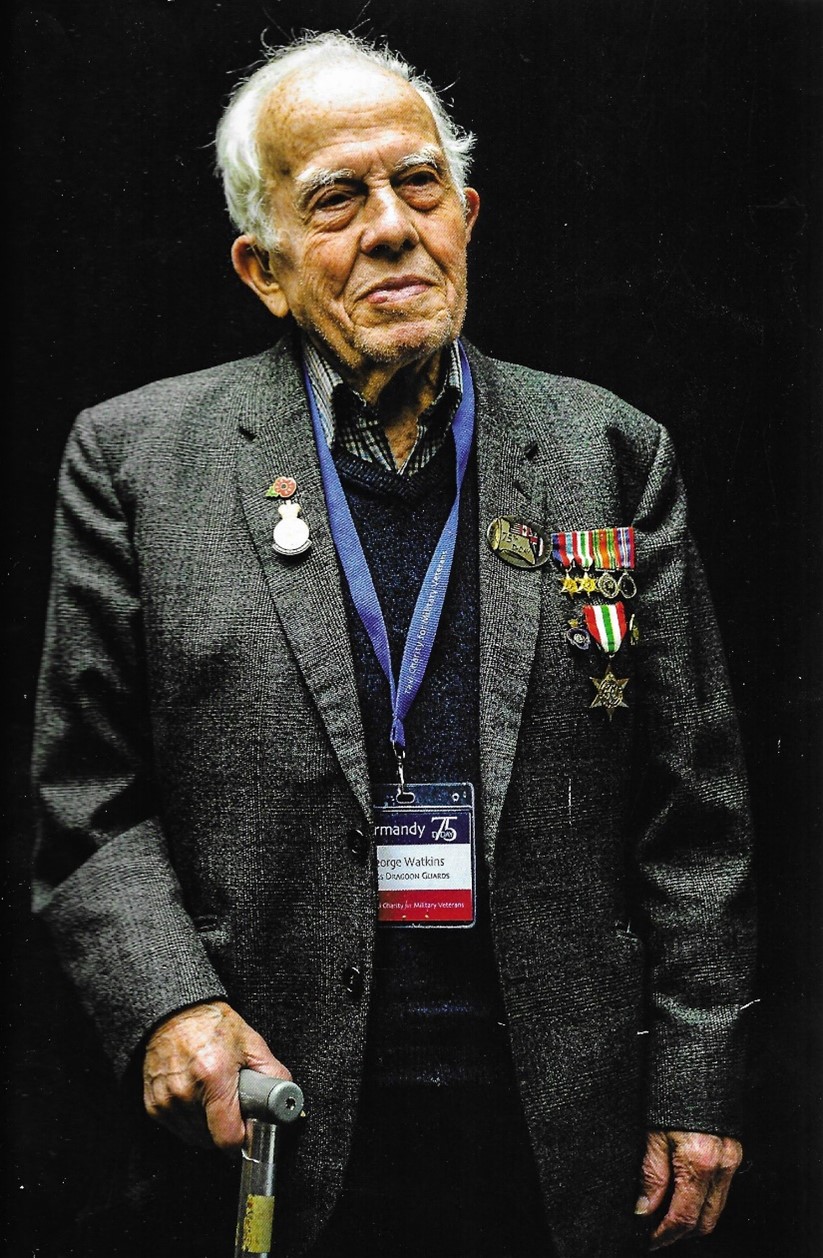 older man in jacket wearing medals