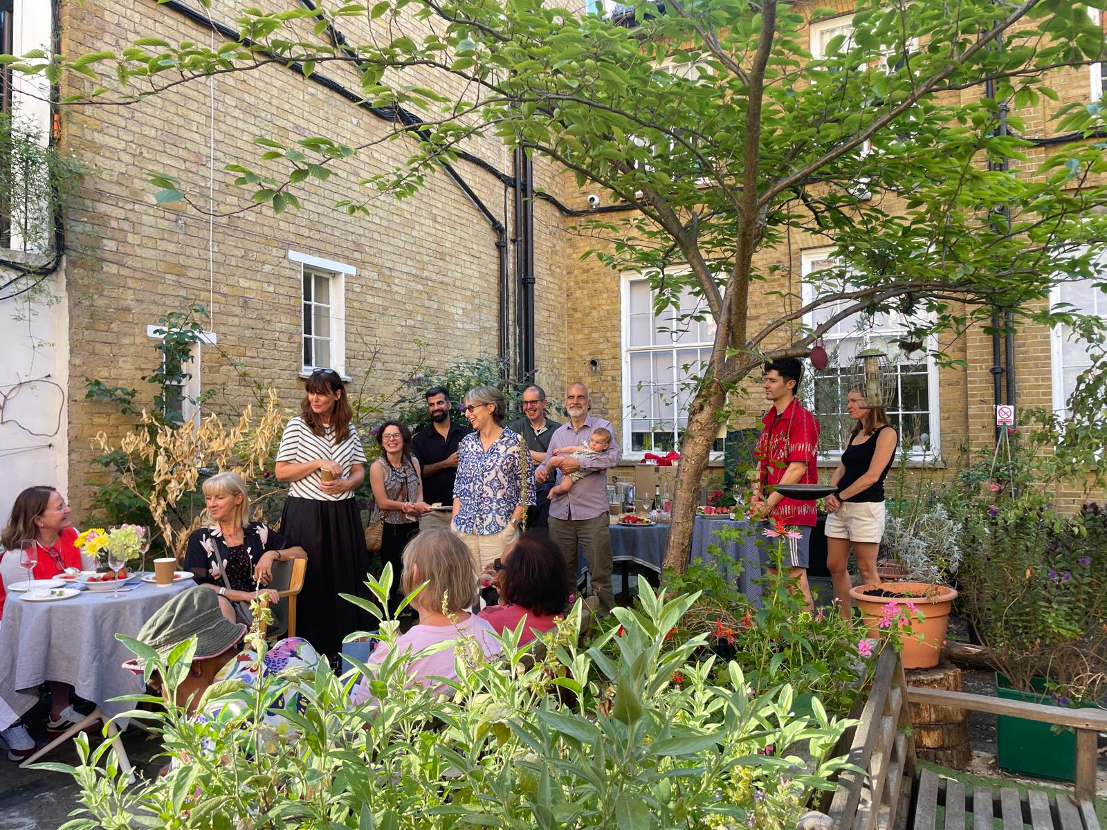 Happy group of people at a small informal outdoor party