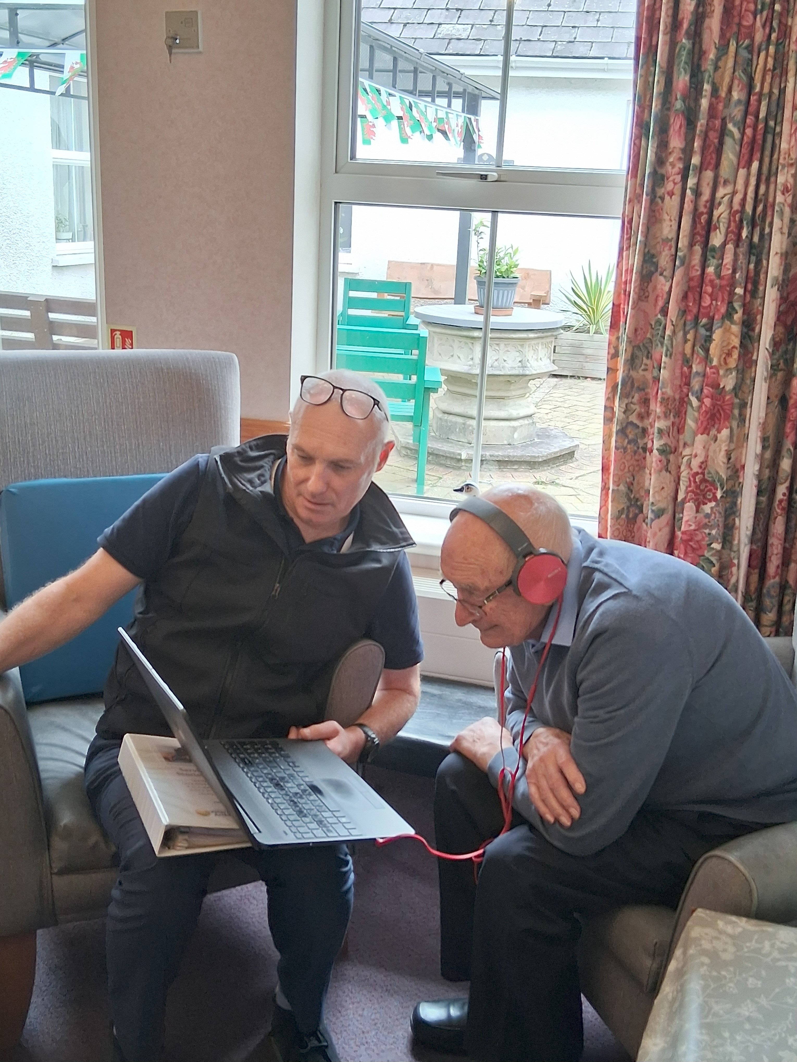 ACD Veterans Officer Neil Davies showing Veteran Dennis Pikes a video recorded for the HLF project