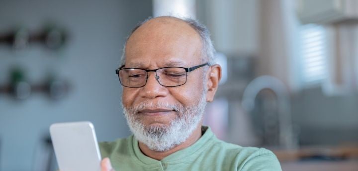 Man smiling looking at phone
