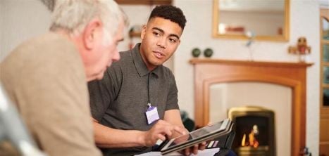 young man talking to older man with a tablet in his hand
