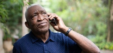 man on phone in blue t shirt