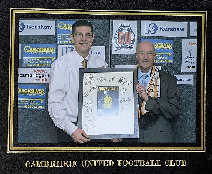 Ken being presented with a framed programme signed by all the players, at his retirement party.