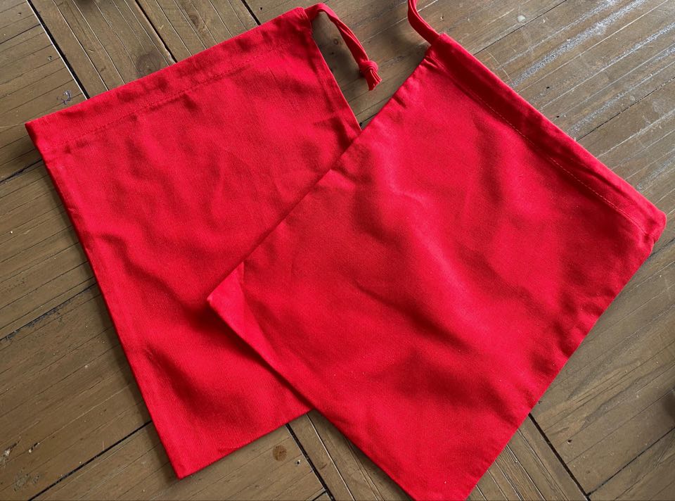 the image shows two small red fabric bags