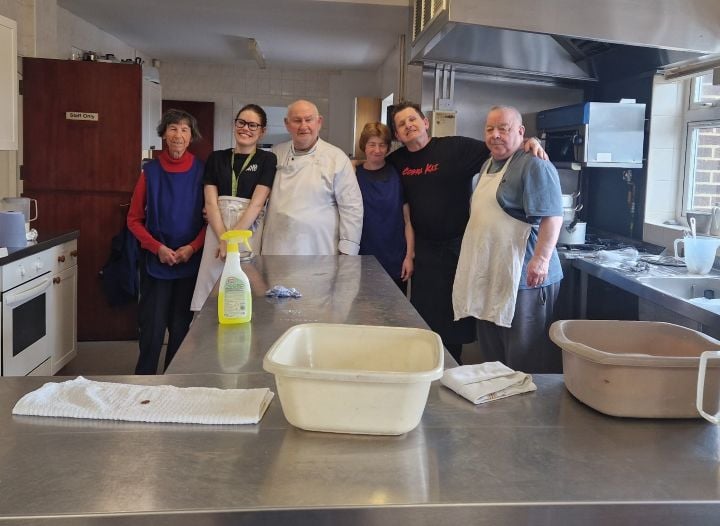 volunteers pose in kitchen of Charles Hunt Centre