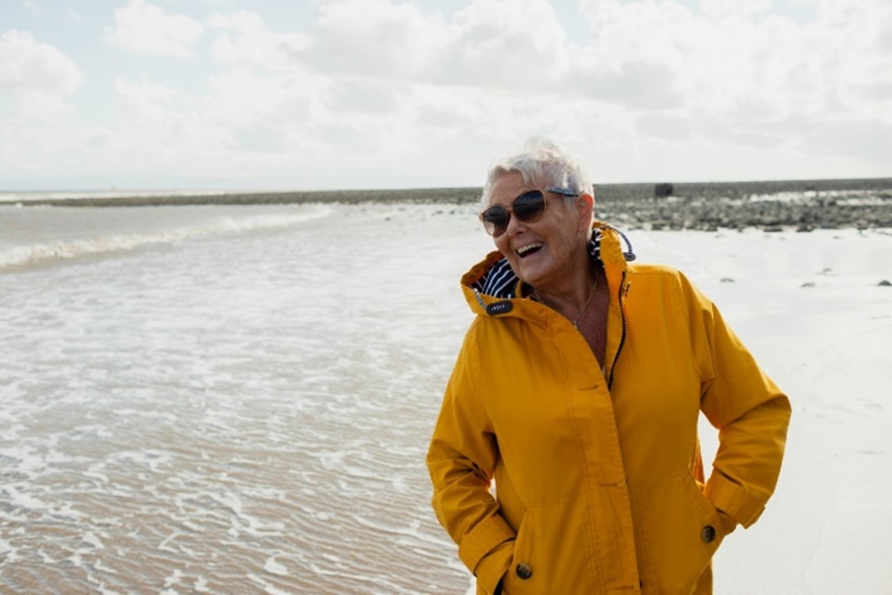 Mental Health - woman in yellow coat smiling