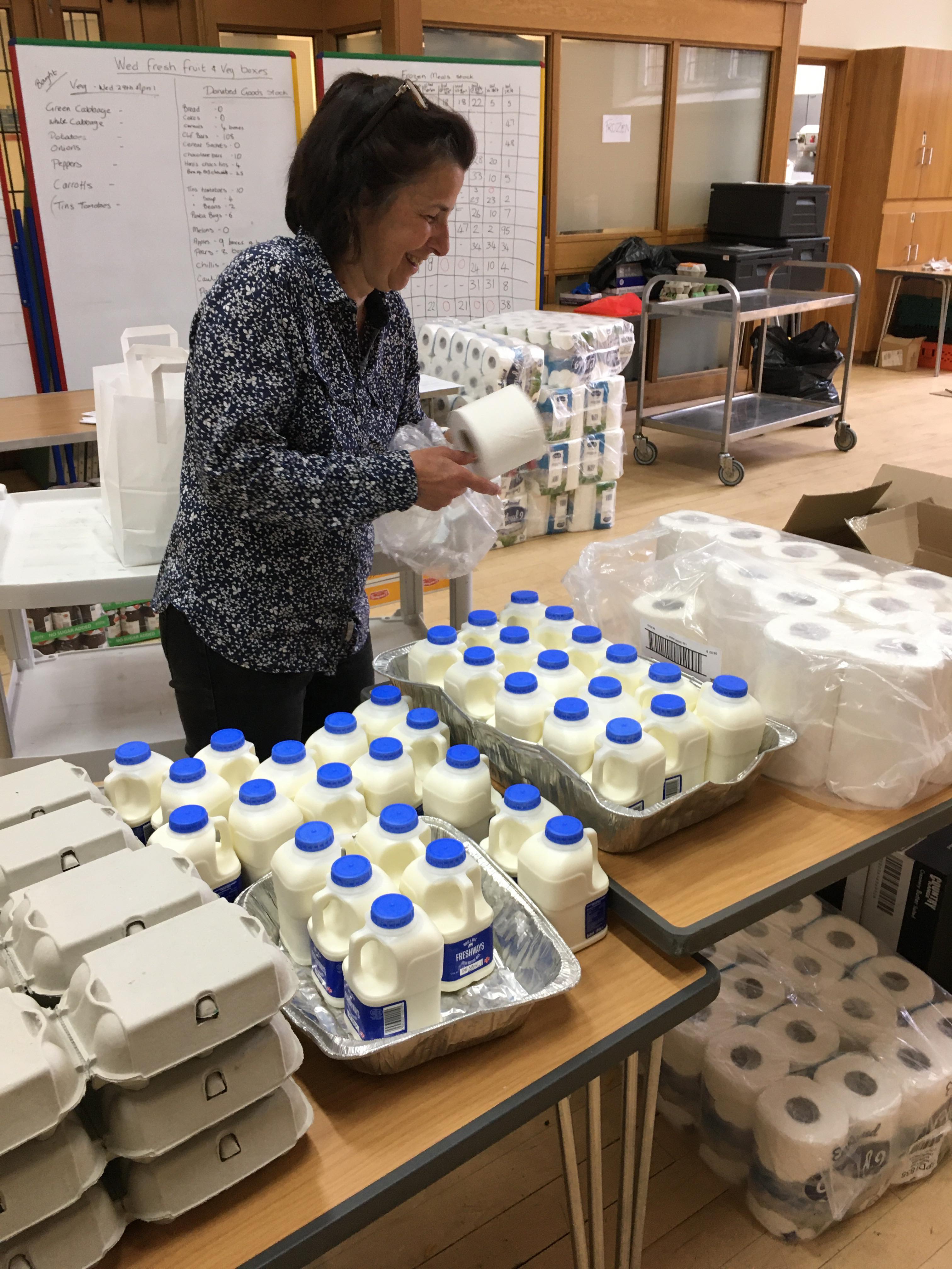 Rev. Karen Cribb helps the team prepare food parcels