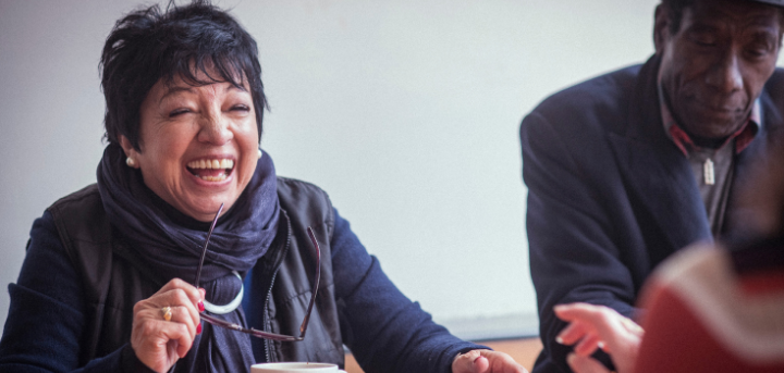 Woman and man in a cafe setting smiling