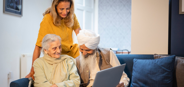 An older Sikh couple looking at paperwork