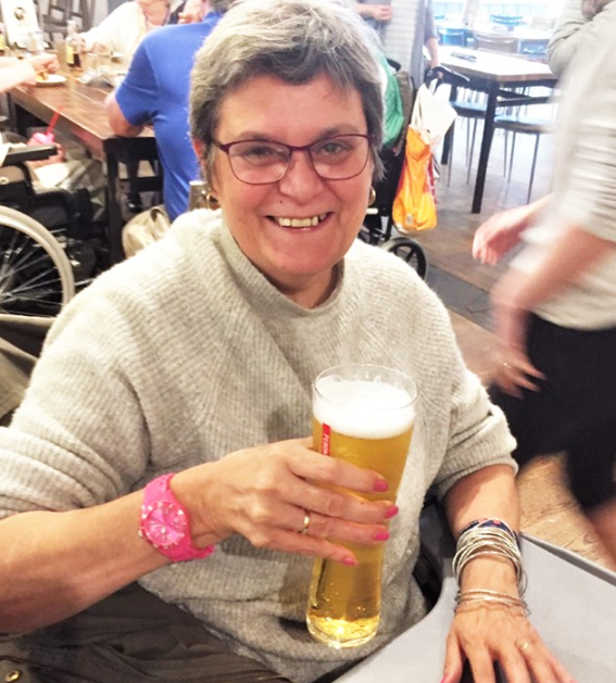 Smiling Nichola Haigh with a pint of lager