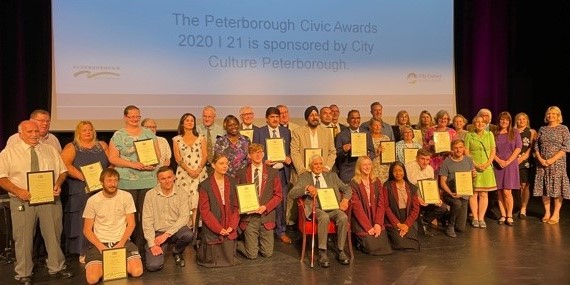 Group of people holding award certificates