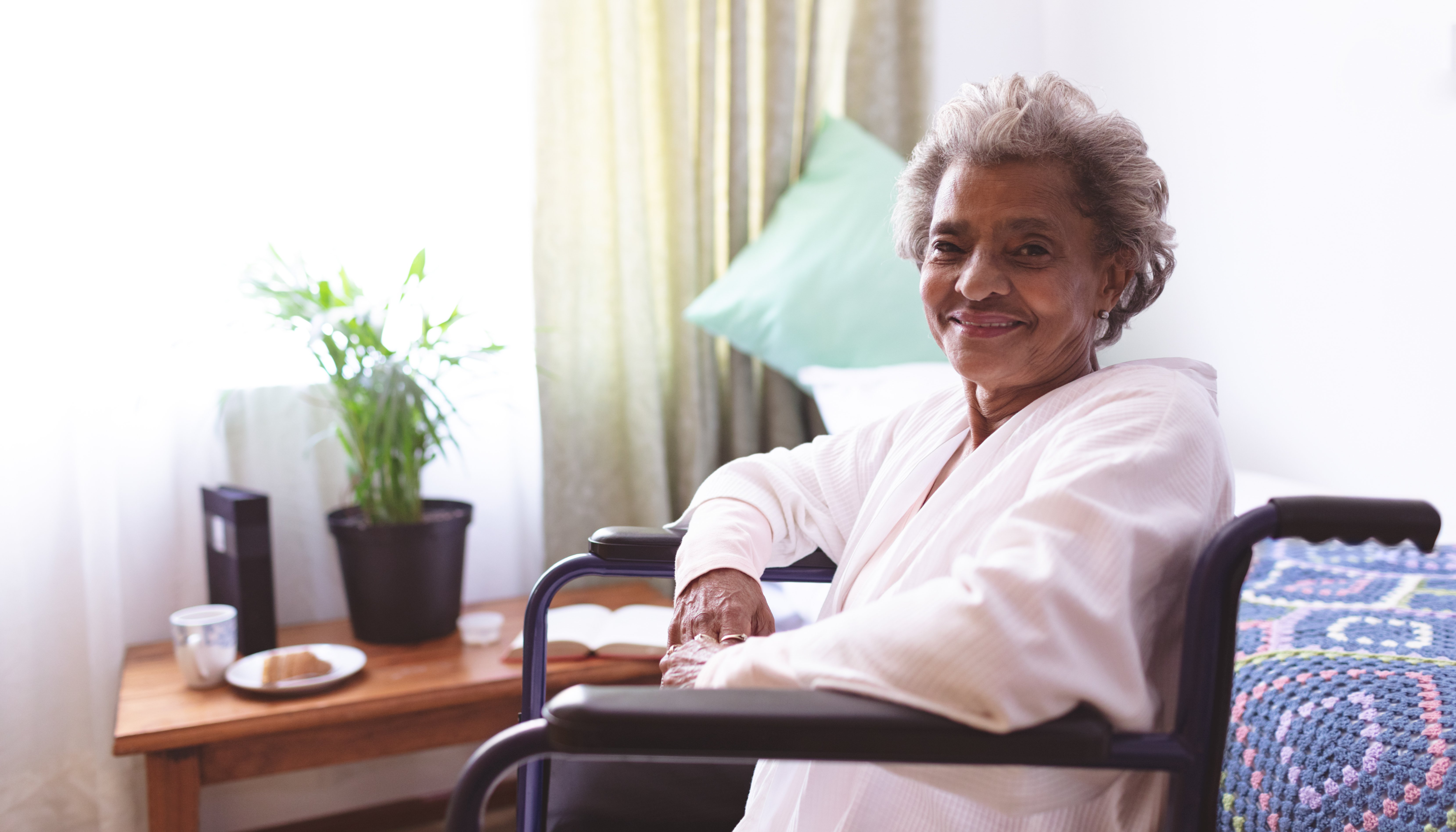 Lady smiling sitting in a wheelchair