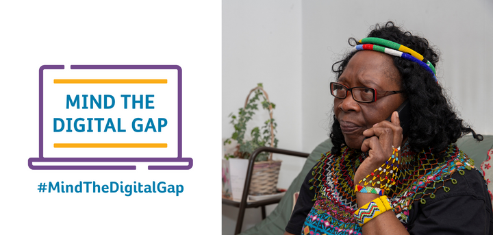 A picture of a lady on the phone next to the campaign logo and hash tag Mind the Digital Gap