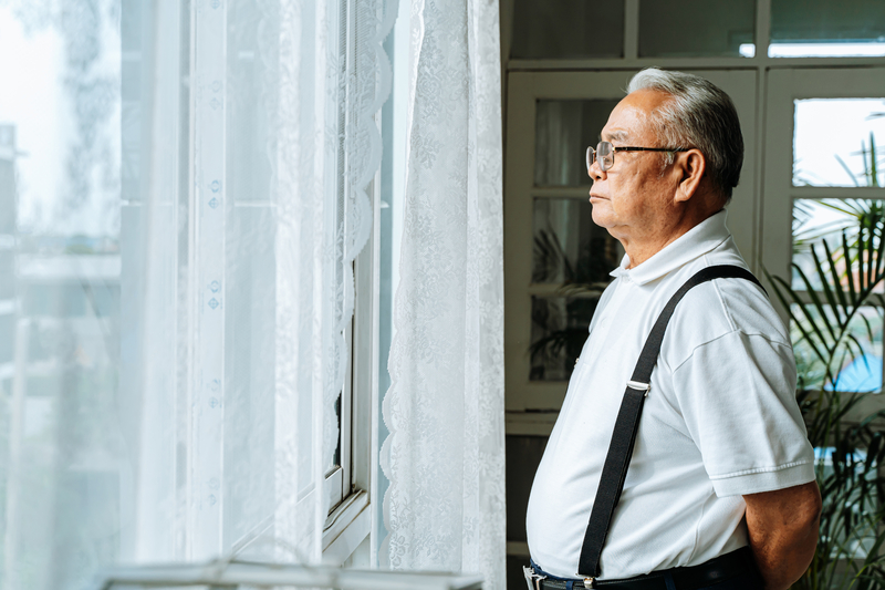 Man looking through window