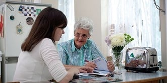  2 people sat at a kitchen table