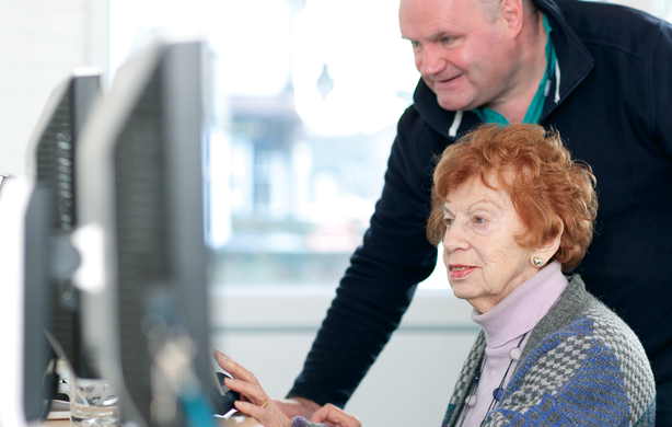 An older lady learns how to use a computer