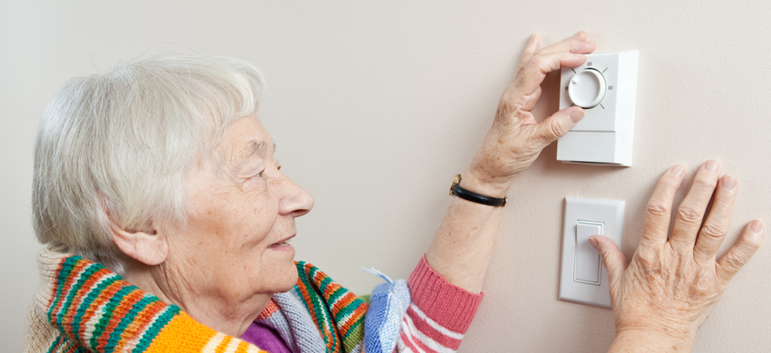 woman turning heating on