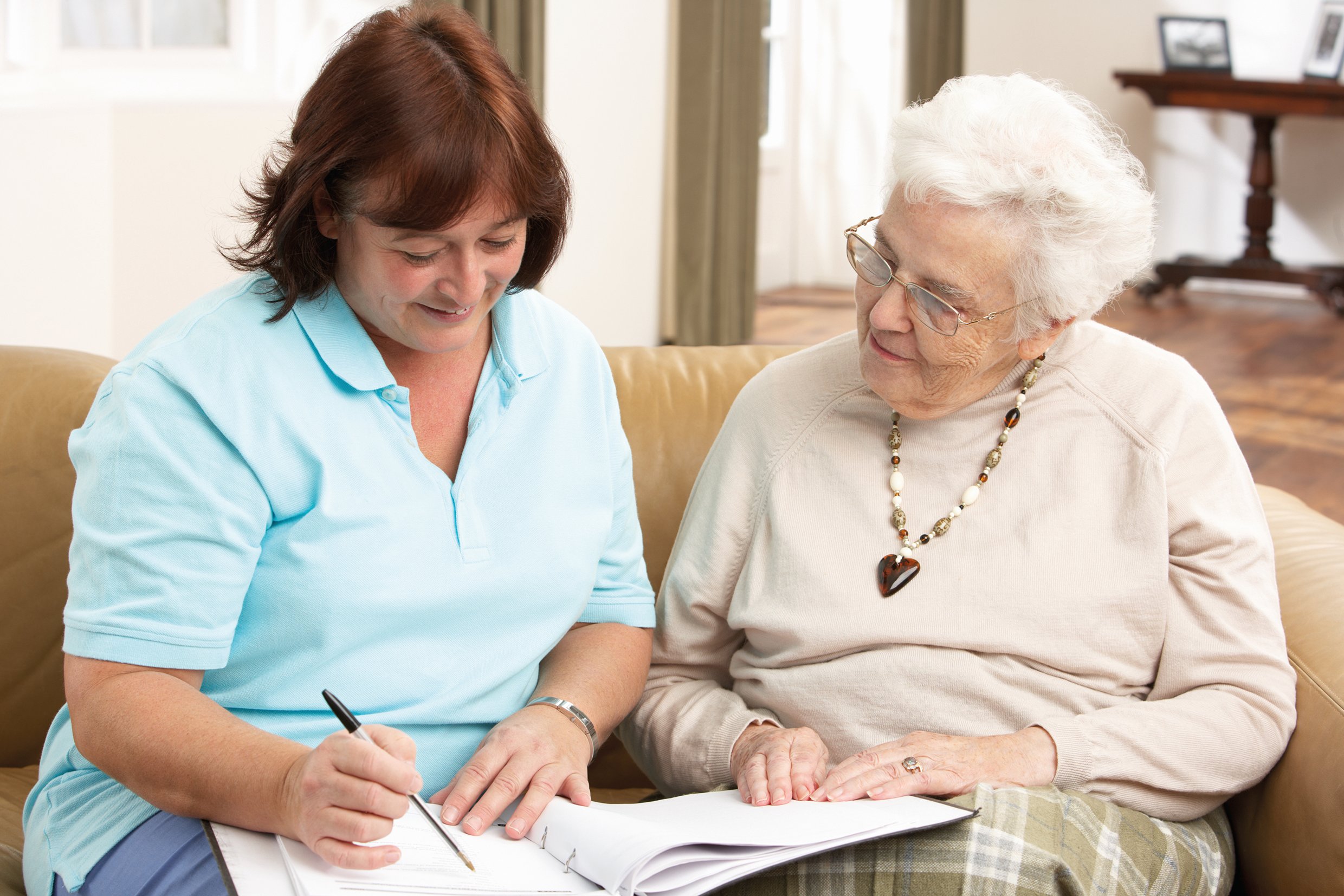 Woman discussing paperwork with an older woman