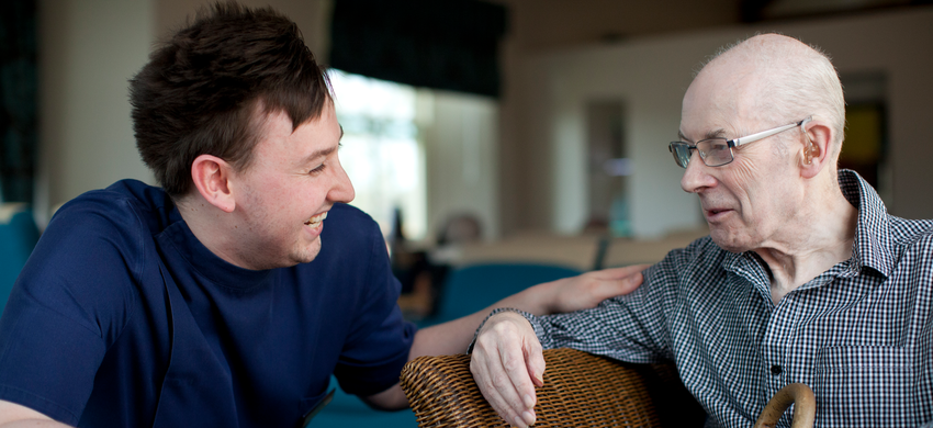 Male carer sharing a joke with male client