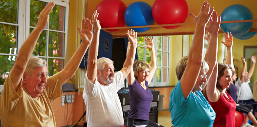 Older people taking part in a fitness ball exercise