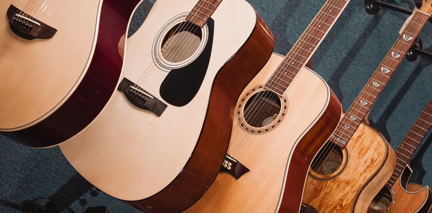 A row of guitars hanging up