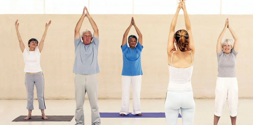 Pilates, Tai Chi and Yoga Older people performing gentle yoga exercises
