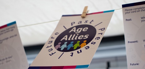 A photo of a set of 3 cards pinned to a washing line. The middle card reads age allies
