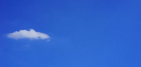 A single cloud against a blue sky.