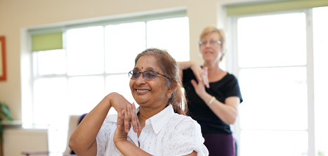 An older woman taking part in an exercise class