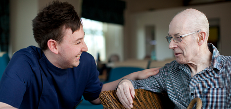 An older man with a carer.