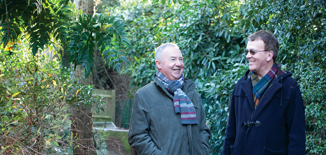 Two men walking in the woods.