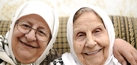 Two women smiling on the sofa