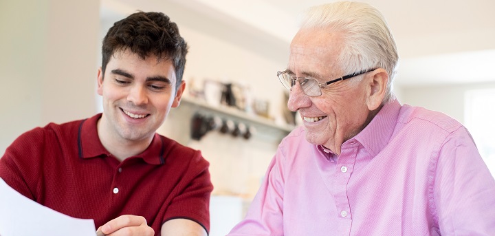 An older person receiving legal advice from a younger person.