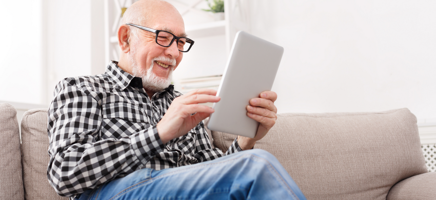 Older gentleman using a tablet.