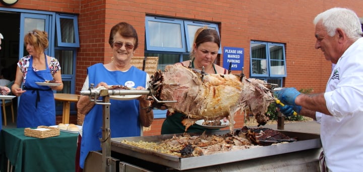 Volunteer Mary helps serve the delicious food