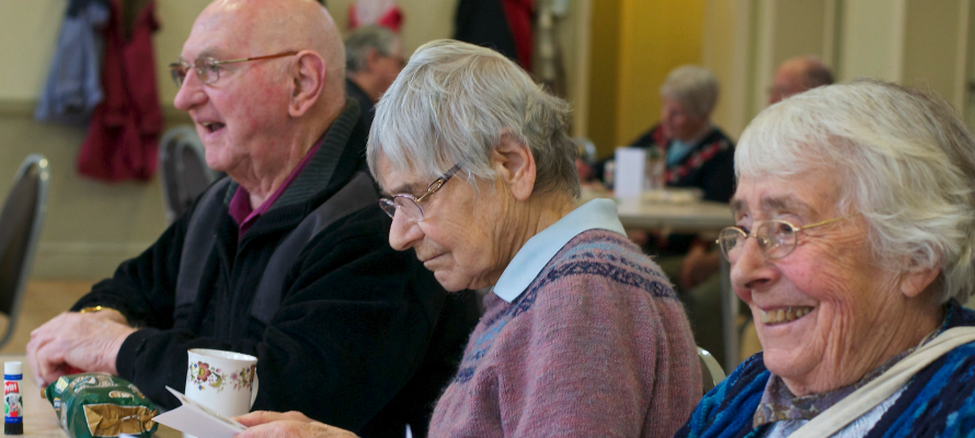 Three older people at a lunch club in North Craven
