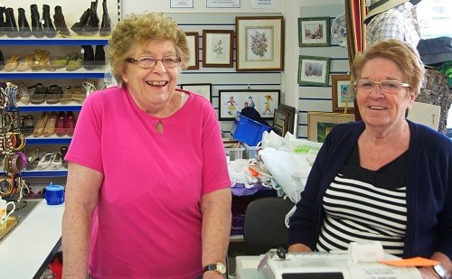 Two ladies volunteering in Age UK North Craven charity shop
