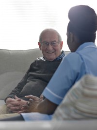 Age UK North Craven home from hospital service Older man sitting with nurse