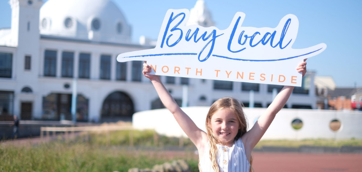 Girl holding buy local sign