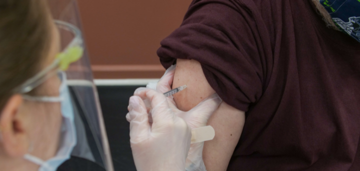 Health care worker giving vaccination