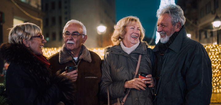 A group of older friends laughing in winter