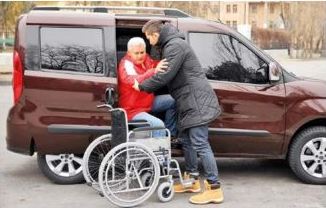 Lady being helped from car