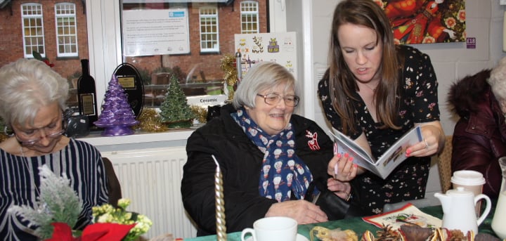 Jean points out her story to Heather.