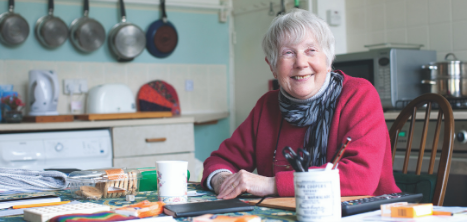 A woman sitting at the kitchen table