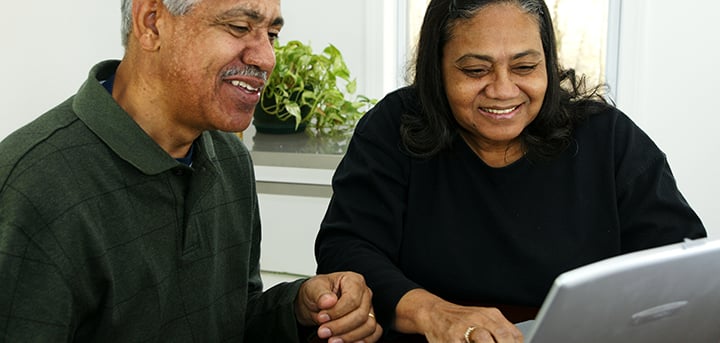 Man and woman sitting at a laptop