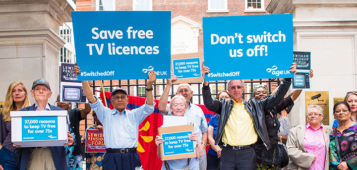 Age UK Switched Off Campaign Members holding up signs