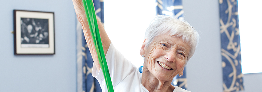 Lady using a resistance band at an exercise class