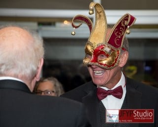 Close up of a Masquerade Ball guest in fancy jester style mask