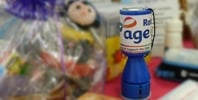 Age UK Rotherham donation tin on shop counter